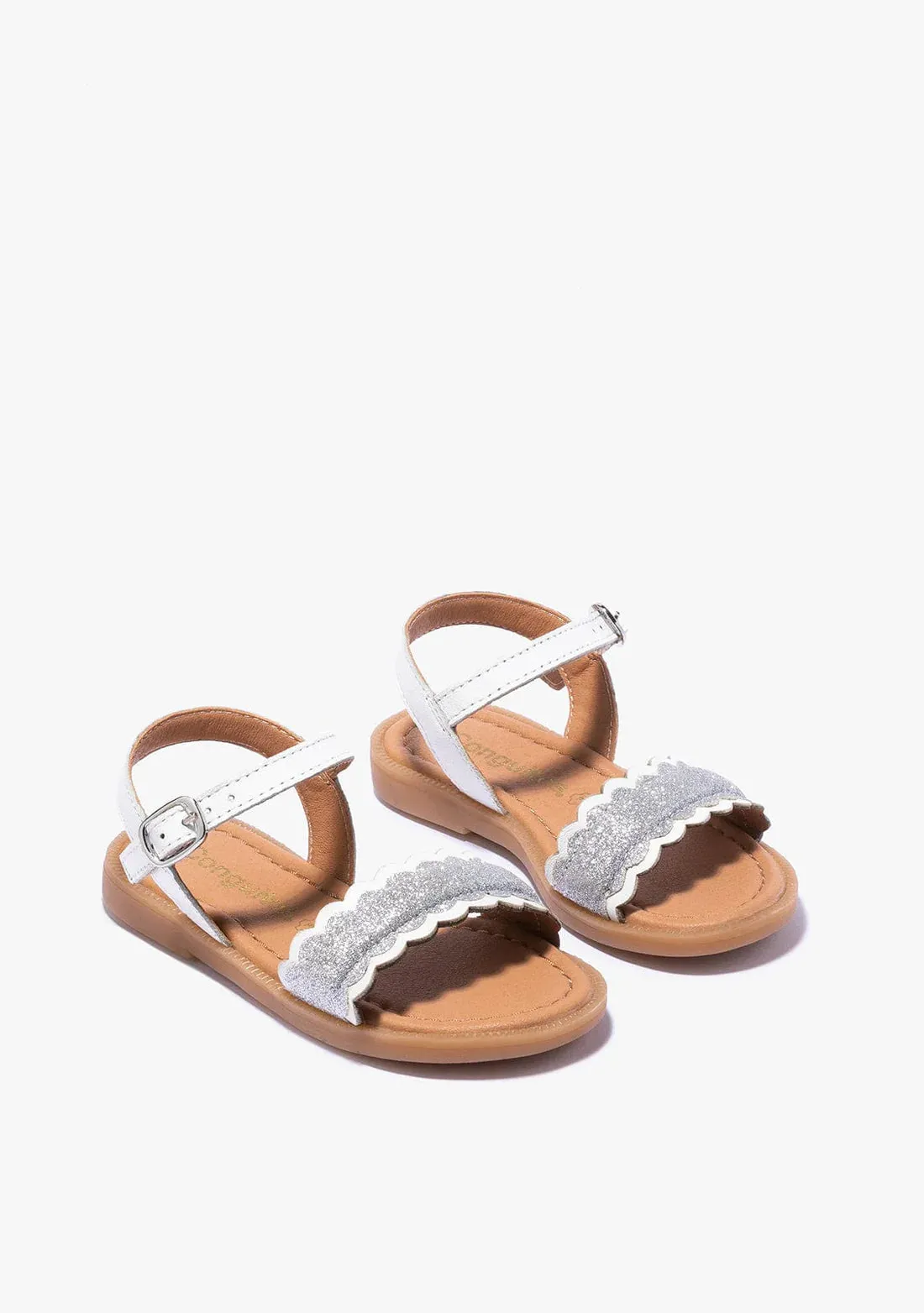 White sandals with silver front detail